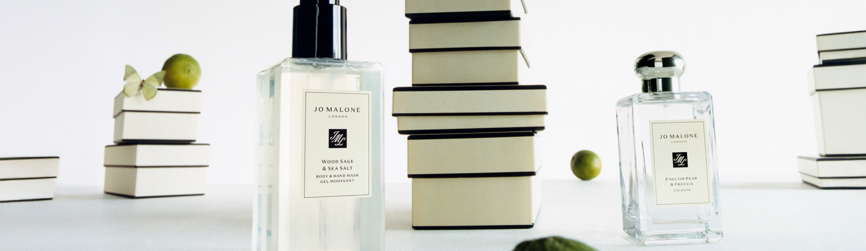 Jo Malone Wood Sage and Sea Salt Body and Hand Wash and English Pear and Freesia Cologne in a white background with giftboxes