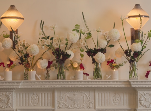 Jo Malone London Frieze Townhouse Candle Collection on mantelpiece with flowers