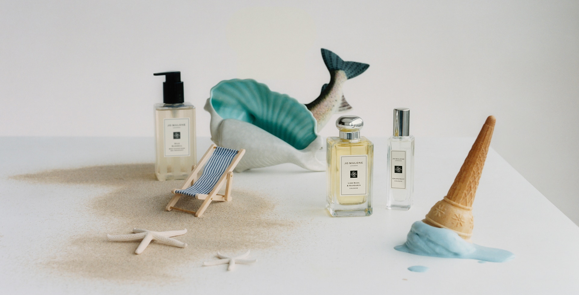 Jo Malone London Colognes and Wash with big shell, beach ornaments and sand 