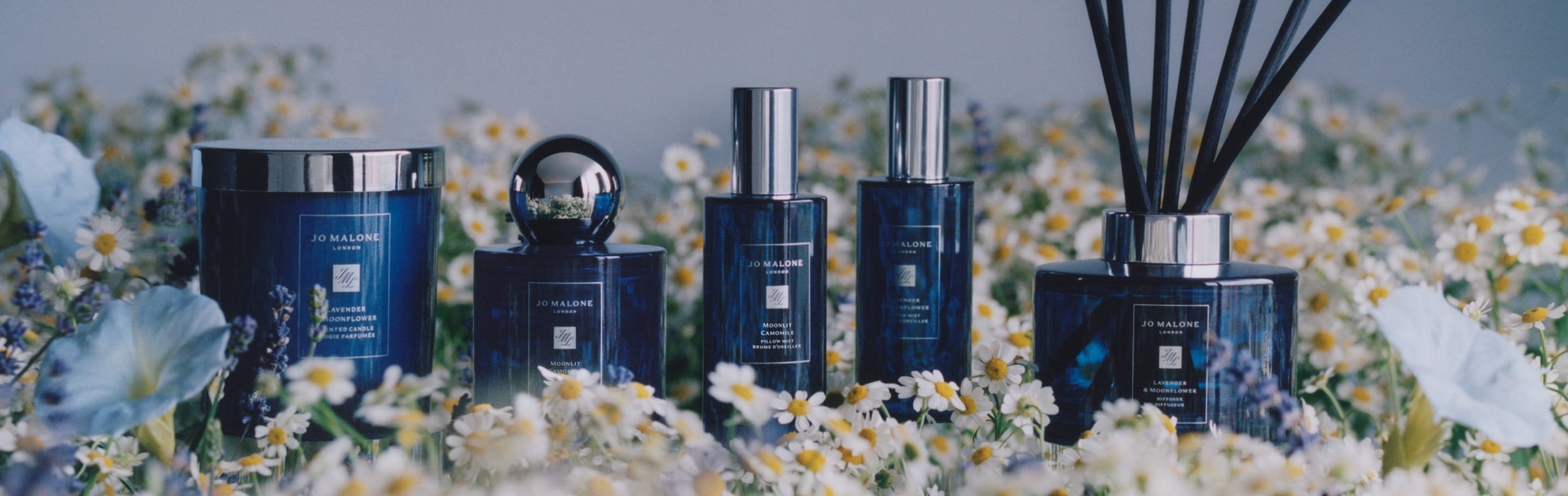 Jo Malone London Night Collection surrounded by flowers 