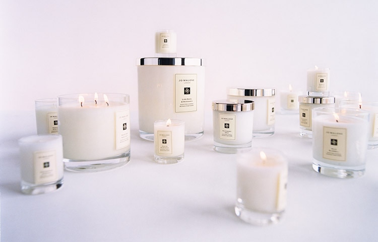 Jo Malone London intense home candles in front of colourful foliage