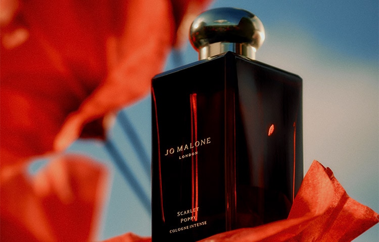 Jo Malone London Scarlet Poppy Cologne Intense surrounded by red flowers