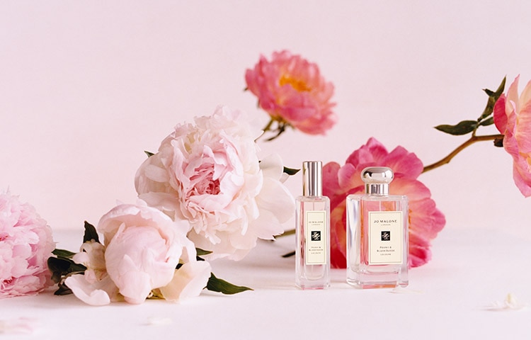 Jo Malone London colognes in front of pink flowers